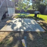 New concrete patio poured beside a brick home in Denver, Colorado